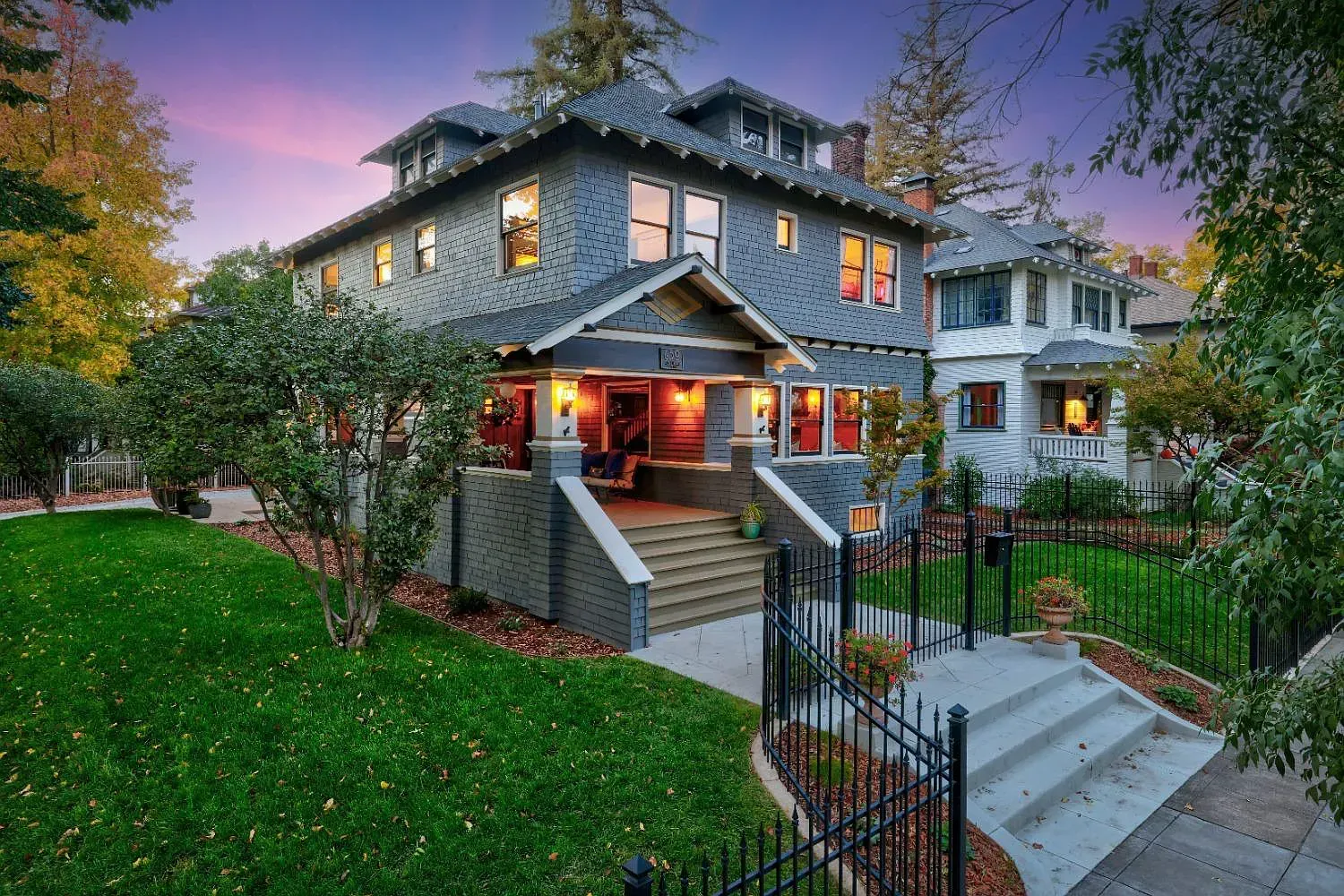 Historic Sacramento homes in a tree-lined neighborhood at dusk